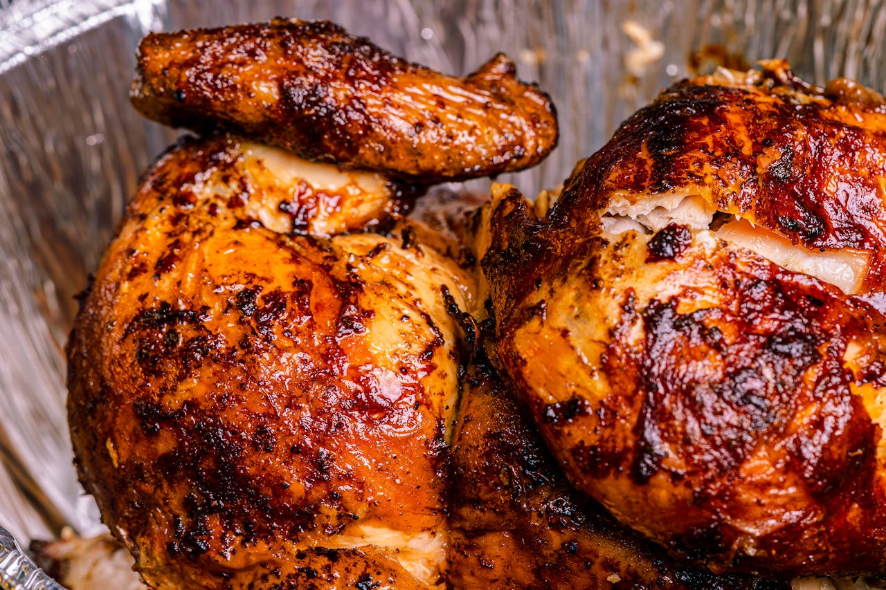 Deliciously roasted rotisserie chicken with crispy skin, perfect for a hearty meal.